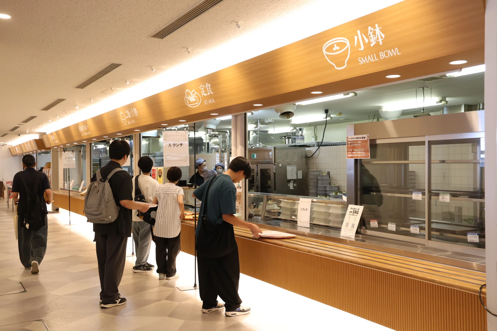 参加者が大学の食堂でランチを受け取る様子