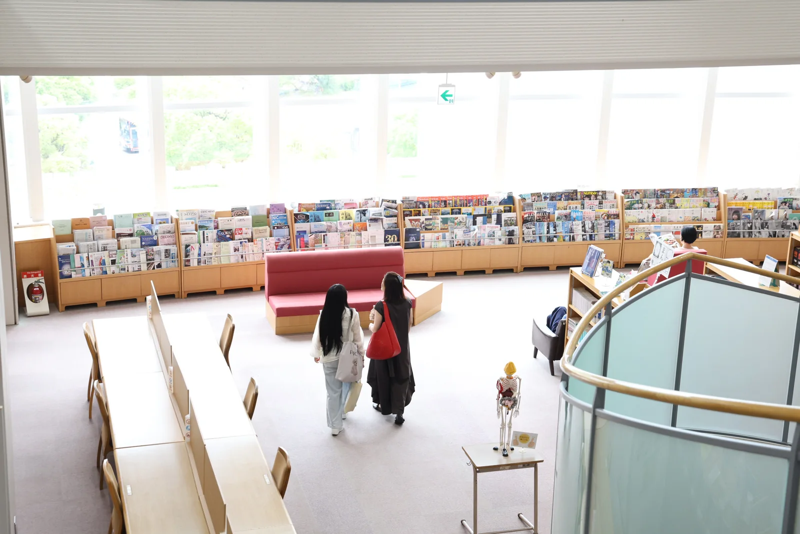 明るく開放的な図書館を参加者が見学する様子